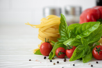 ingredients for fettuccine pasta with tomatoes and basil