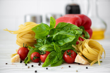 ingredients for fettuccine pasta with tomatoes and basil