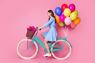 Full length body size profile side view of attractive cheerful wavy-haired lady riding bike wearing smart casual journey delivering shop order quarantine service isolated pink pastel color background