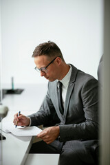 Handsome businessman working in the office. Young man preparing for the meeting.	