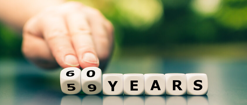 Hand turns dice and changes the expression "59 years" to "60 years".