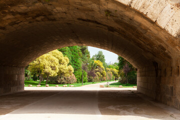 The arched structure of the old bridge in Turia Park, Valencia, Spain.