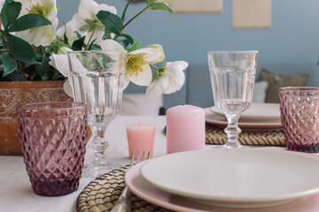 Stylish crockery on dining table at modern home interior. Table set for event party. Catering and eating concept.