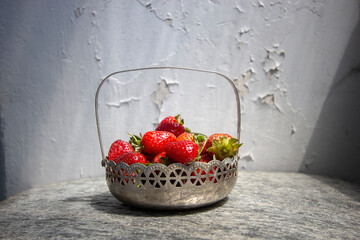 juicy fragrant strawberries in a beautiful metal vintage vase