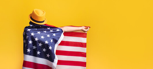 girl with American flag over yellow background, girl in fashionable hat with USA flag