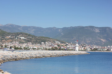 Alanya, TURKEY - August 10, 2013: Travel to Turkey. Berth with boats, boats and yachts. Clear blue sky. The waves of the Mediterranean Sea. Water surface.
