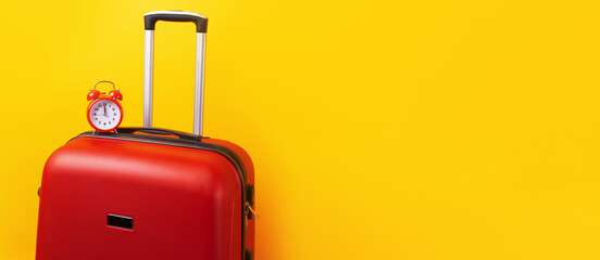 Travel case with alarm clock  over yellow background. Time to voyage. Voyage concept. Retro alarm clock with red suitcase, panoramic mock-up