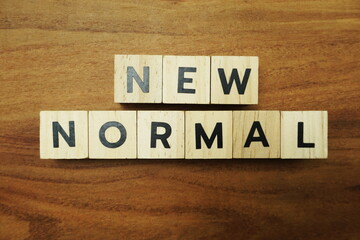 Naklejka premium New Normal alphabet letters on wooden background