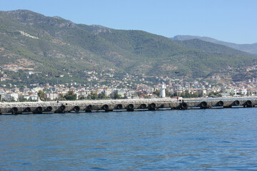 Alanya, TURKEY - August 10, 2013: Travel to Turkey. Greenery. Flowers. Green hills. The mountains. Rocks, wildlife of Turkey. Forest and clear blue sky. The waves of the Mediterranean Sea. Water surfa