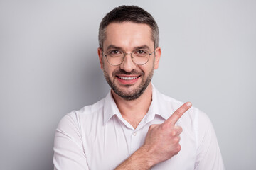 Close-up portrait of his he nice attractive cheerful cheery mature man demonstrating copy empty...