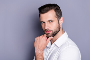 Close-up portrait of his he nice attractive virile brutal brunet guy model unshaven beard posing touching chin thinking isolated over gray pastel color background