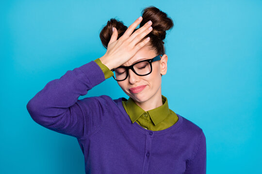 Photo of pretty stressed student lady two buns eyes closed arm on forehead can't remember historic date classroom wear specs shirt collar violet sweater isolated blue color background