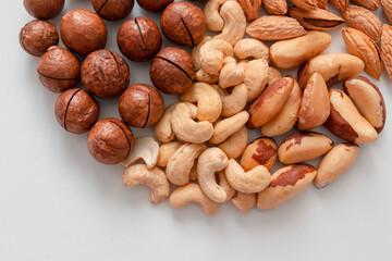 Obraz premium Background of mix nuts pecan, macadamia, walnut, almonds, hazelnuts Top view, flat lay