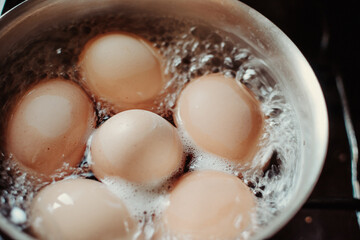 Eggs are boiling with high temperature. Cooking chicken eggs in pot. Boiled eggs.