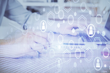 Social network theme hologram with businessman working on computer on background. Concept of world...