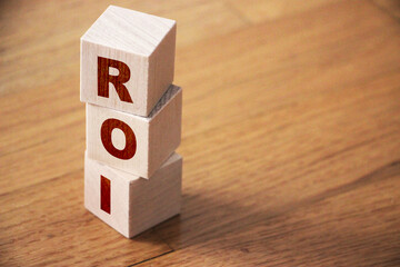 ROI letters meaning Return on Investment on wooden cubes. Business concept.