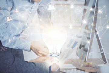 Social network theme hologram with businessman working on computer on background. Multi exposure.