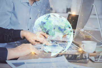 Social network theme hologram with businessman working on computer on background. Multi exposure.