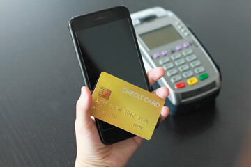 A woman using credit card on smartphone  for buy products in the shop. Concept of spending via credit card on line shopping.