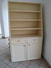 White kitchen cabinet on a beige wall. Woodworking made in MDF.