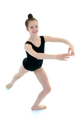 Fototapeta premium Little girl gymnast in a sports swimsuit.