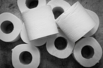 Many toilet paper rolls on a gray background. Diarrhea, constipation concept