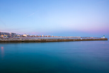 Entrance of Les Sables D'Olonne harbour taken from La Chaume, with it piers and lighthouse at sunset, Vendee, France