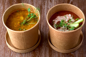 two fresh Lentil soup, tomato soup in takeaway box