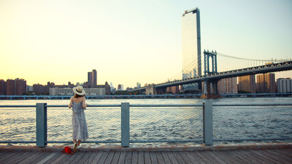 Young woman on the embankment in summer