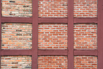 Pattern of traditional half-timbered house wall with red brick - 366915409
