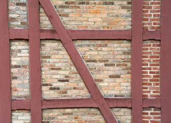 Pattern of traditional half-timbered house wall with red brick - 366915463