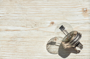 small vacuum glass electronic retro light bulb on the wooden background
