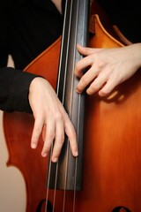 close up of a man playing a double bass