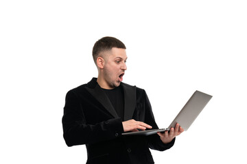A shocked man holds a laptop in his hands and looks at him with surprise with his mouth open and big eyes. Isolated