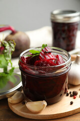 Delicious pickled beets and spices on wooden table