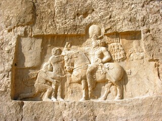 Stone carving in bas-relief on the Tomb of Darius the Great at Persepolis, Iran