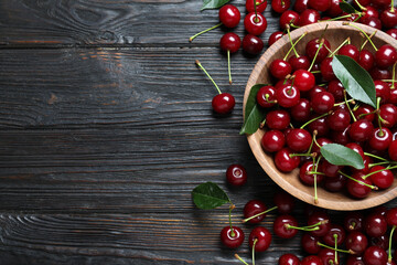 Delicious ripe sweet cherries on dark wooden table, flat lay. Space for text © New Africa