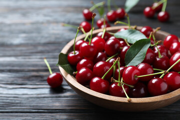 Delicious ripe sweet cherries on dark wooden table, closeup