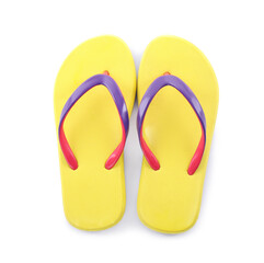 Pair of stylish yellow flip flops isolated on white, top view. Beach object