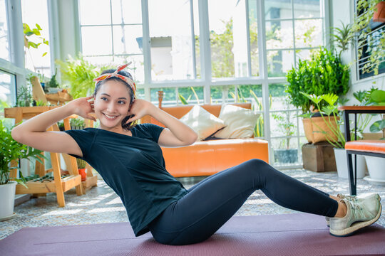 Smile happy Beautiful young Asian woman stretching exercise workout at home, fitness sport girl aerobic and healthy concept.