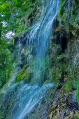 Fototapeta premium Urach Waterfall, Germany - The Urach Waterfall in summer, Bad Urach, Swabian Alb, Baden-Wurttemberg, Germany.