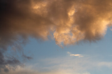 Cumulus cloud. Sunset. Delicate blue sky. Beautiful natural background.