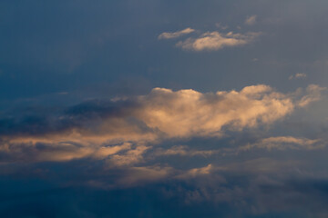 Obraz premium Dark blue sky, cumulus clouds. Sunset.
