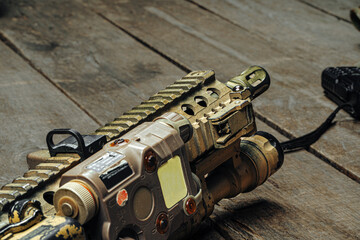 Close up photo of M16 rifle on wooden board