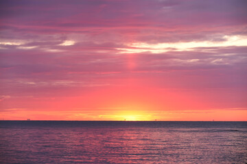 Colorful red sunset sunrise at sea. Water and sky. Minimalism in nature. Dark photo at dusk. Sea landscape.