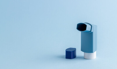 Inhaler on a blue background. Medicine. Health. Respiratory diseases. Mock-up.