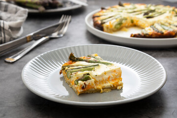 Slice of asparagus tart. Homemade pie filled with fresh asparagus. Vegan food.