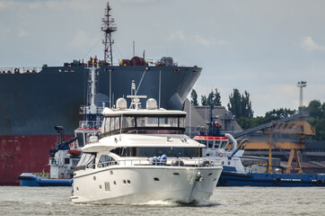 Naklejka premium MOTORBOAT - A luxurious recreational boat is sailing out to sea 
