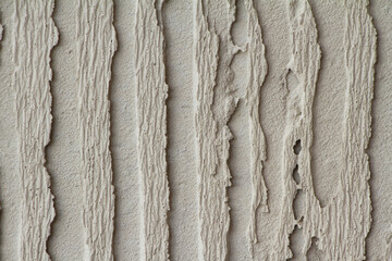 Fototapeta na wymiar Background of gray old concrete wall. Decorative embossed concrete and glue plaster. Gray plastered wall. 