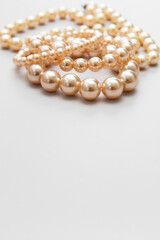 White pearls on the gray background, isolated. Abstract fashion background.